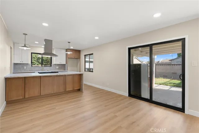 a large kitchen with kitchen island a sink stainless steel appliances and counter space