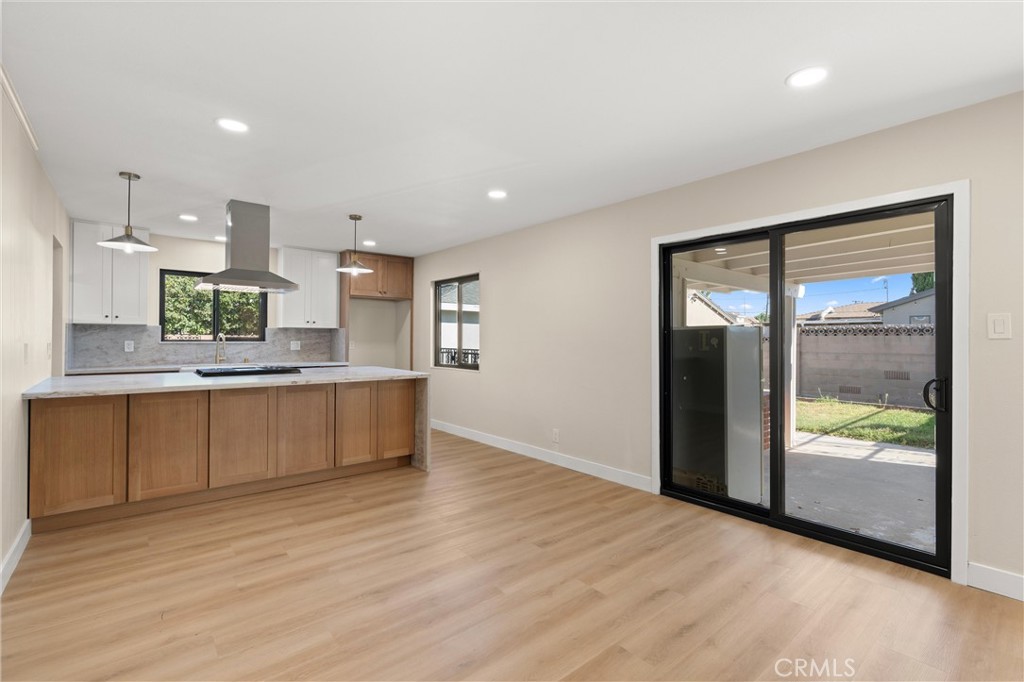 13562 Springdale Street Westminster, CA 92683 - Photo 10 of 34 a large kitchen with kitchen island a sink stainless steel appliances and counter space