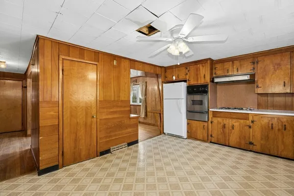 a kitchen with stainless steel appliances a refrigerator and cabinets