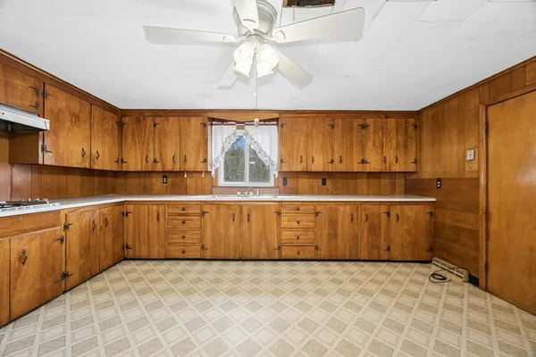 a kitchen with a refrigerator a sink and cabinets