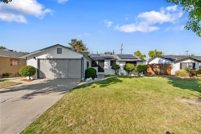 a front view of houses with yard