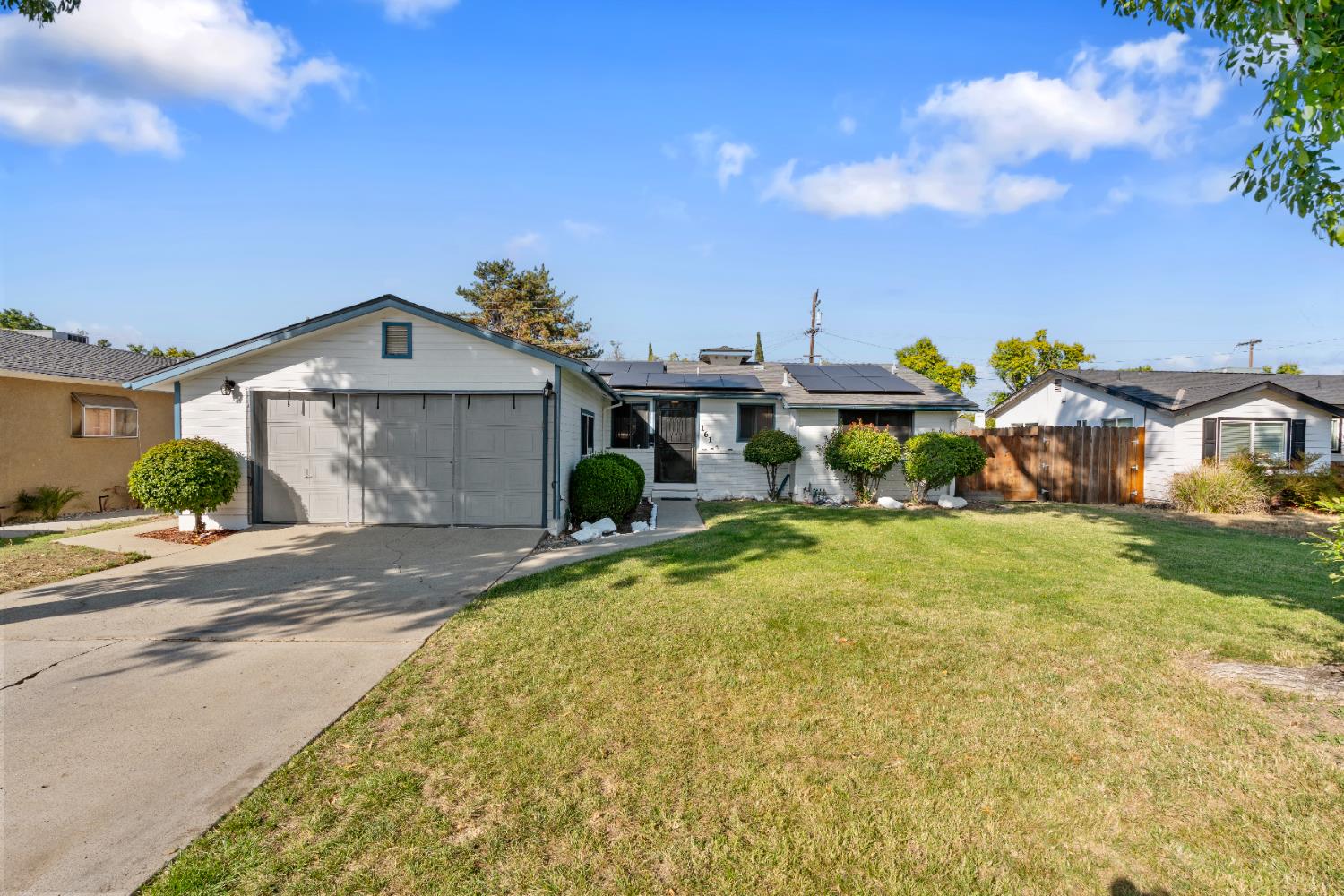 a front view of houses with yard