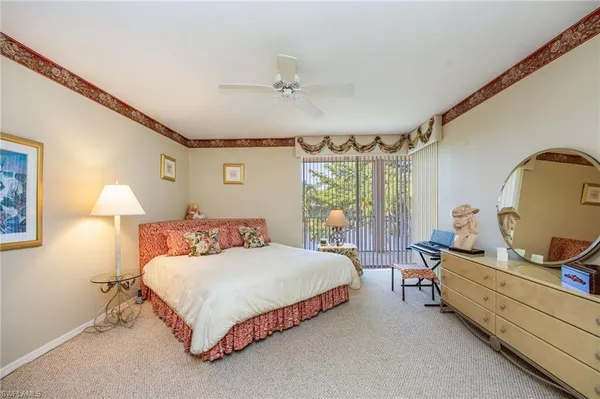 a bedroom with a bed chair and window