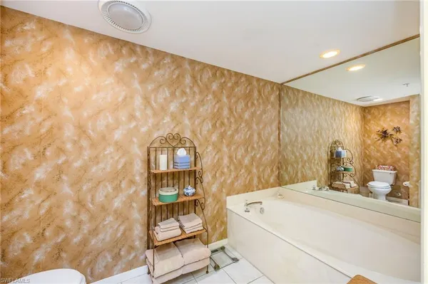 a bathroom with a sink a toilet and shower curtain