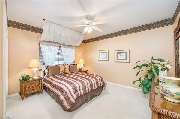 a bedroom with a bed and a potted plant