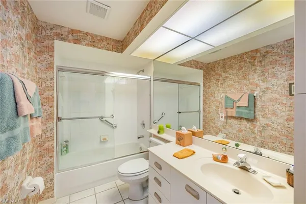 a bathroom with a sink toilet tub and shower