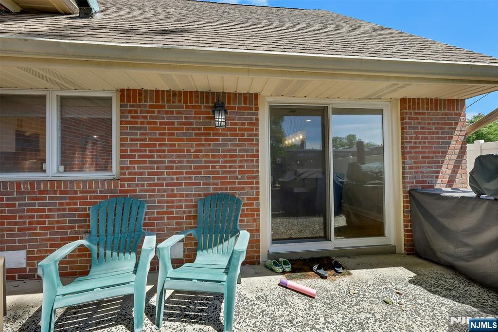 514 Rutland Avenue Teaneck, NJ 07666 - Photo 32 of 40 a view of a patio with table and chairs and floor to ceiling window