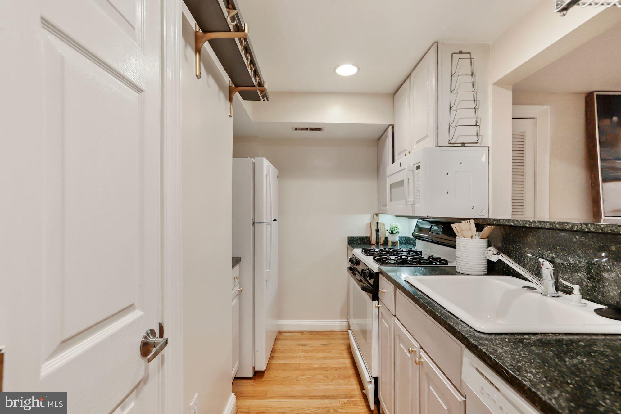 1713 18th Street Northwest, Unit B Washington, DC 20009 - Photo 11 of 23 a kitchen with a sink stove and refrigerator