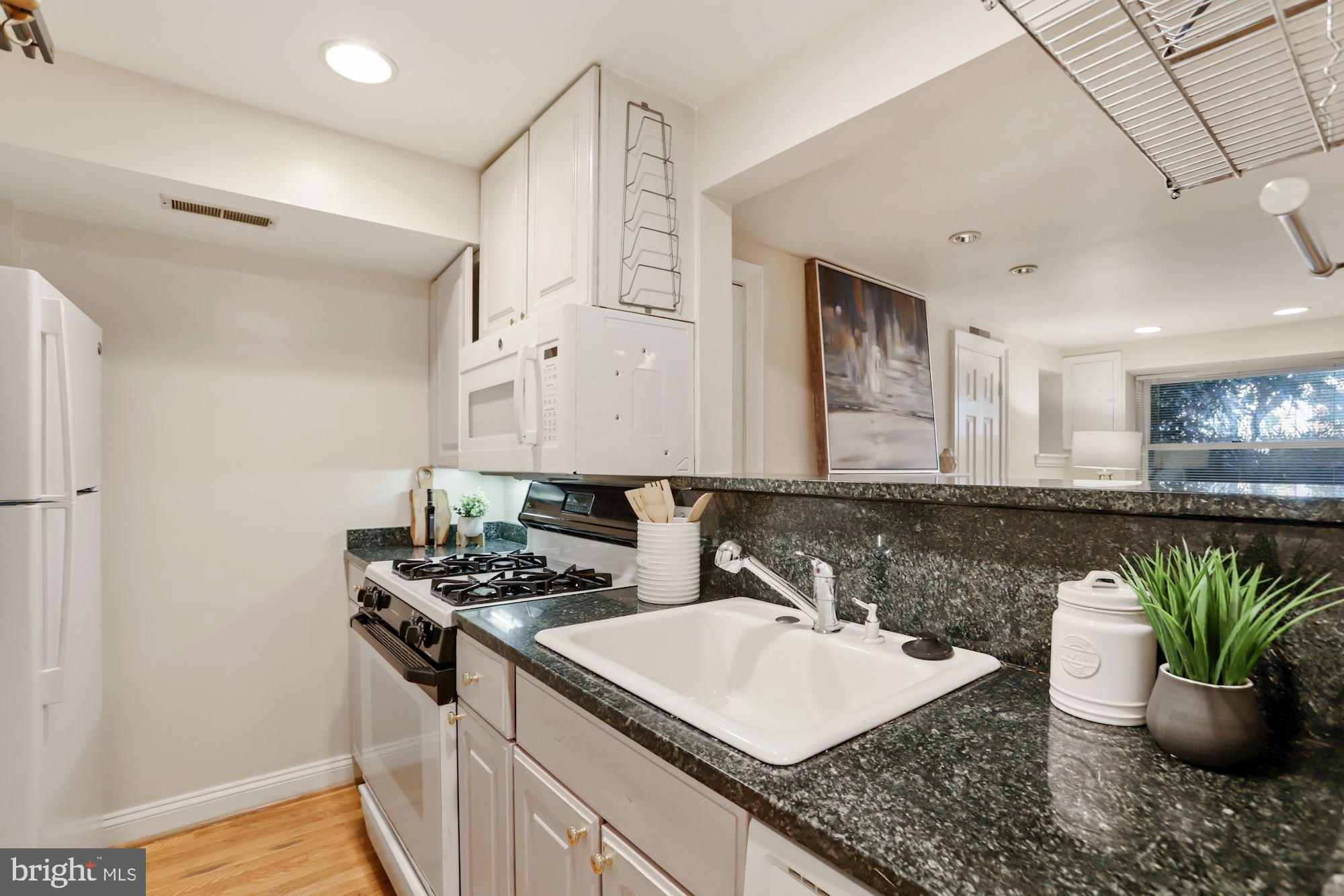 1713 18th Street Northwest, Unit B Washington, DC 20009 - Photo 12 of 23 a kitchen with a sink a counter and cabinets