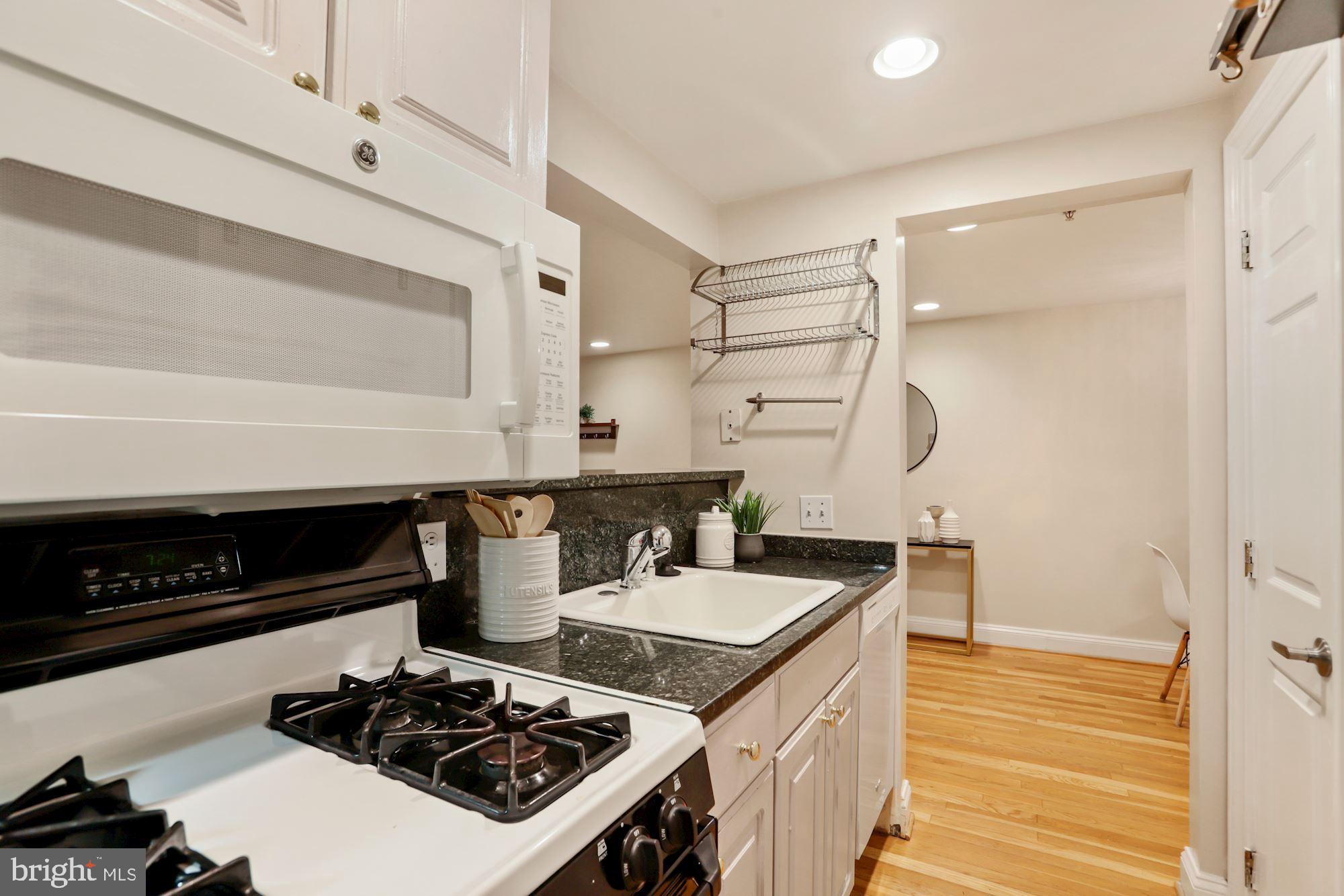 1713 18th Street Northwest, Unit B Washington, DC 20009 - Photo 13 of 23 a kitchen with a stove and a refrigerator
