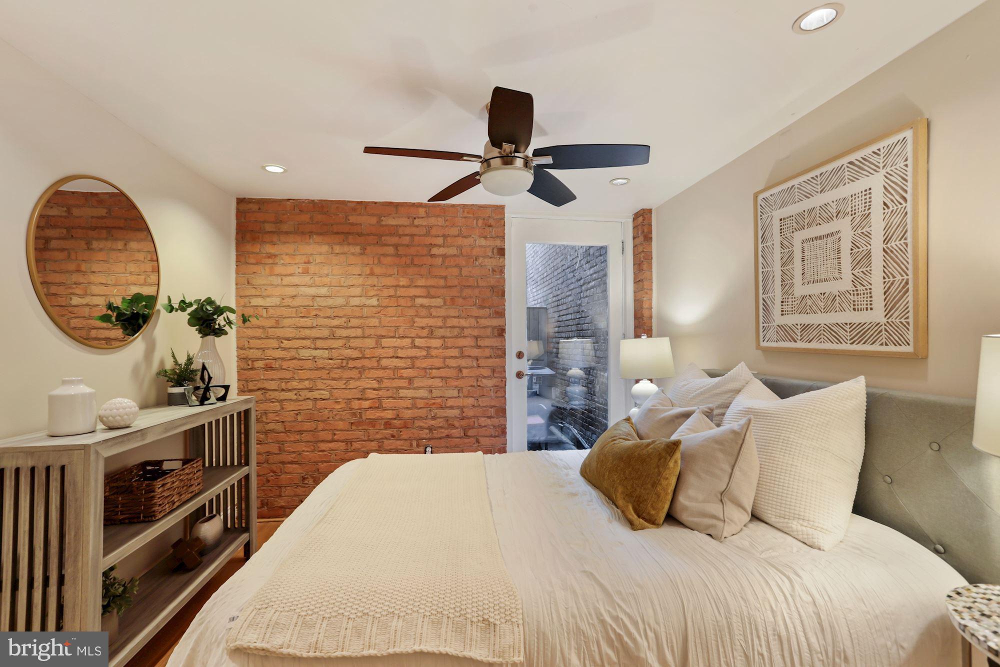 1713 18th Street Northwest, Unit B Washington, DC 20009 - Photo 14 of 23 a bedroom with a bed and a chandelier