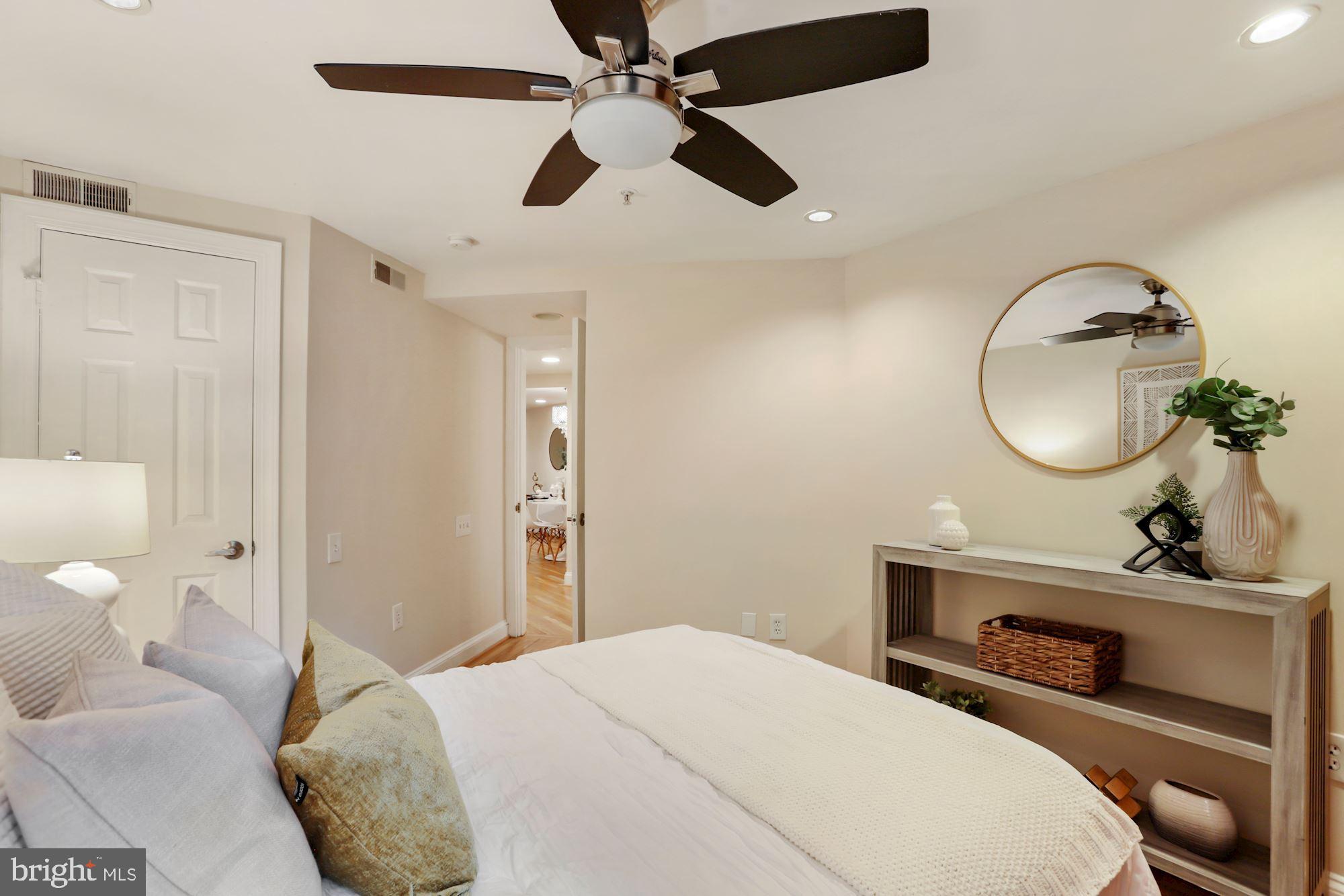 1713 18th Street Northwest, Unit B Washington, DC 20009 - Photo 16 of 23 a bedroom with a bed a mirror and a chandelier