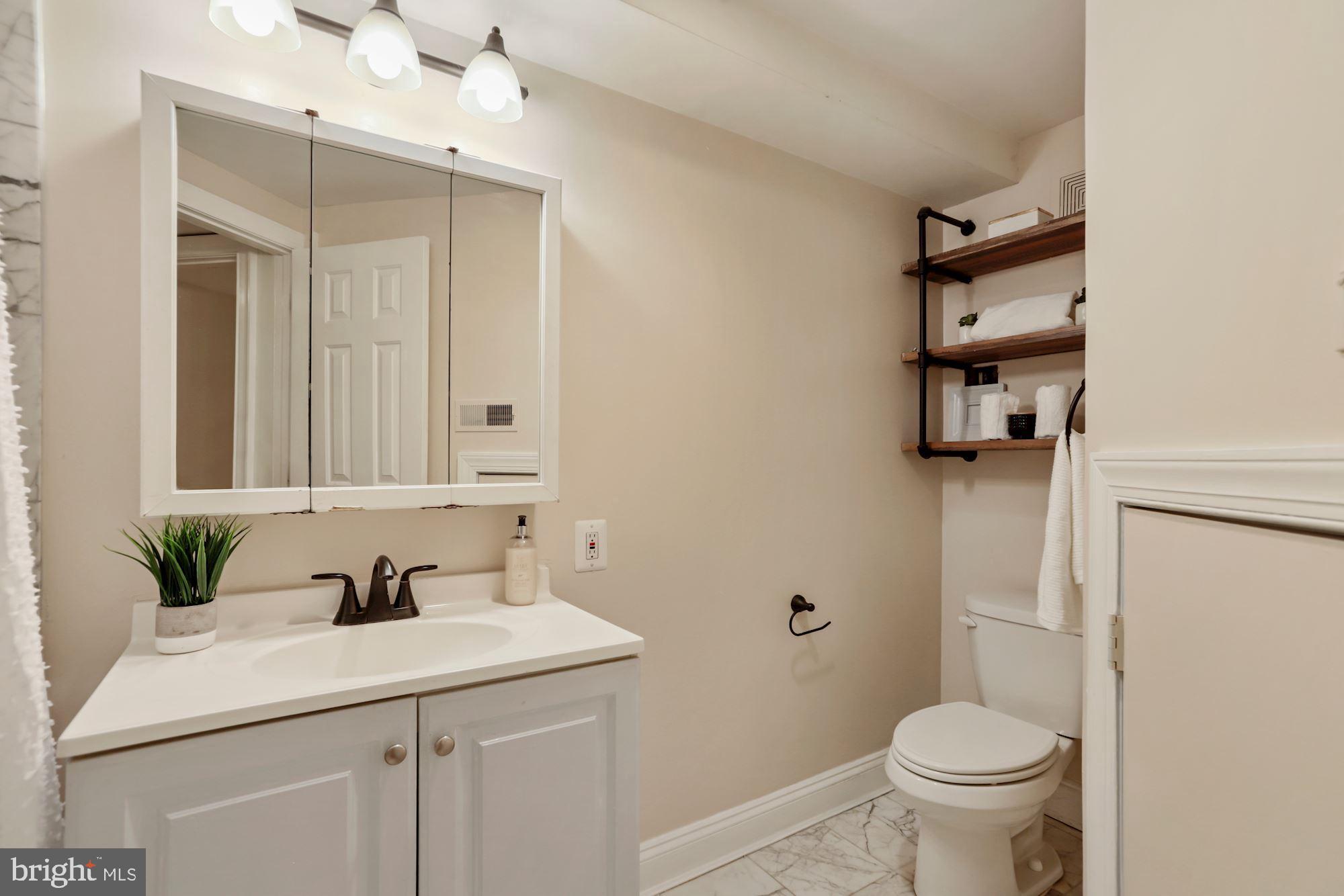 1713 18th Street Northwest, Unit B Washington, DC 20009 - Photo 17 of 23 a bathroom with a sink a toilet and shower