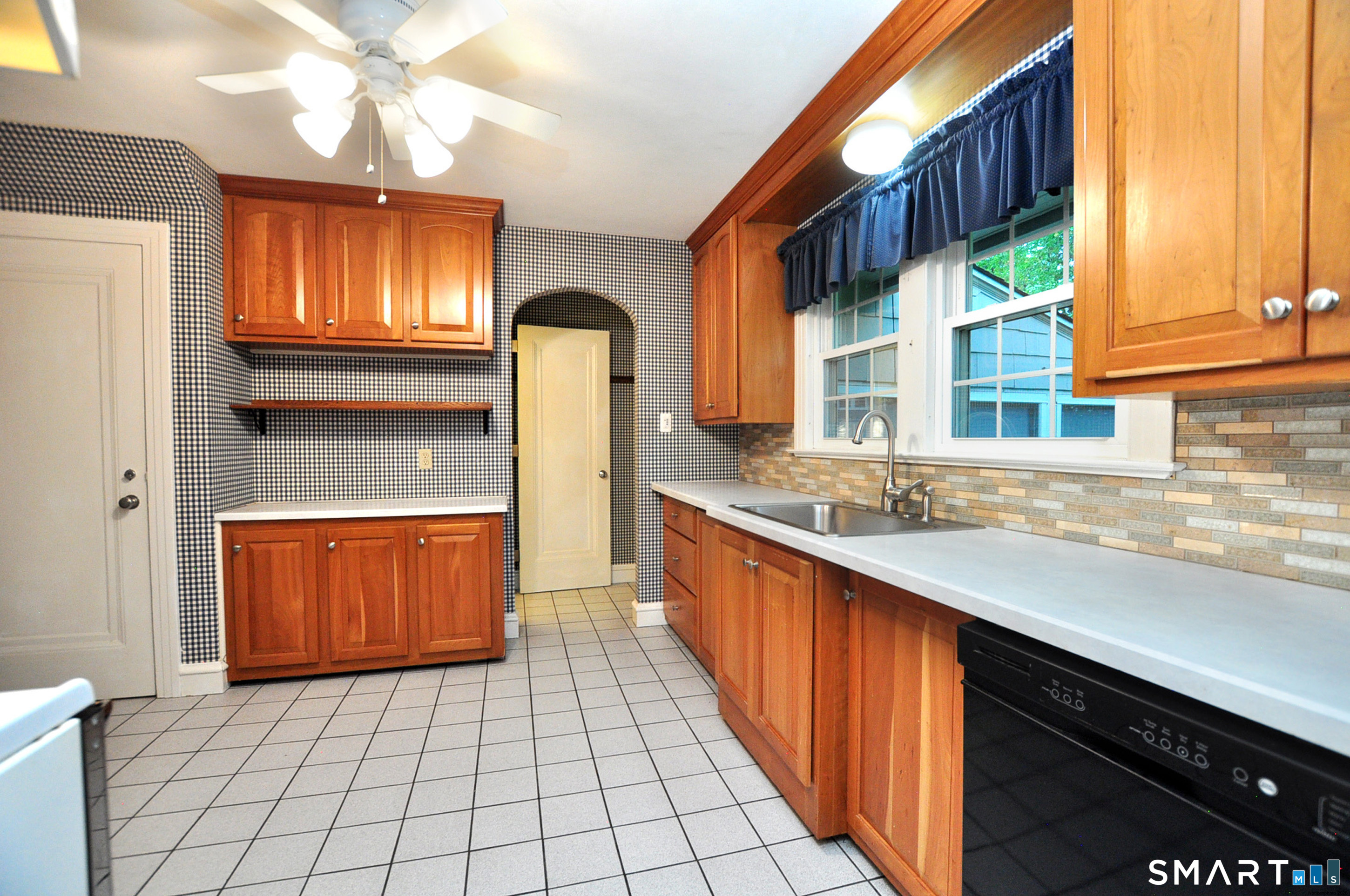 10 Harvey Road Windsor, CT 06095 - Photo 10 of 36 a kitchen with stainless steel appliances a sink cabinets and a large window