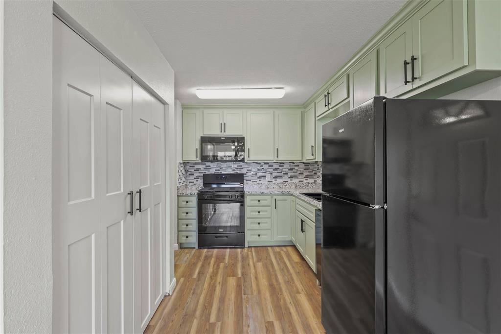 732 Bullock Street Denison, TX 75020 - Photo 7 of 29 a kitchen with stainless steel appliances a refrigerator and microwave