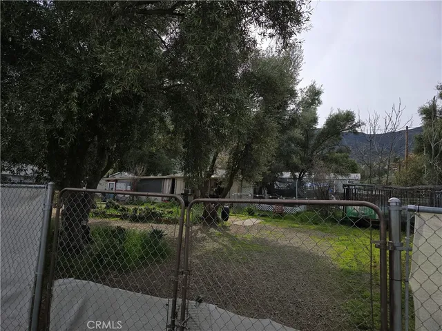 a view of a swimming pool with a patio and a yard