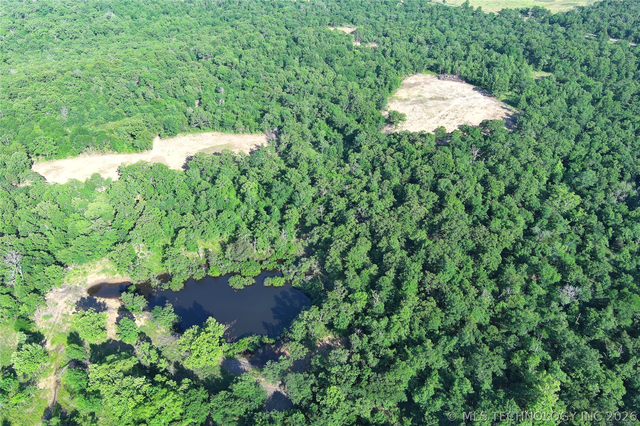 20862 East 1160th Road Keota, OK 74941 - Photo 3 of 47 Expansive wooded acreage featuring a natural pond and multiple cleared land parcels