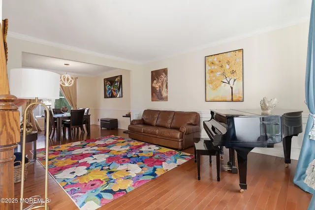 a view of a dining room with furniture and chandelier