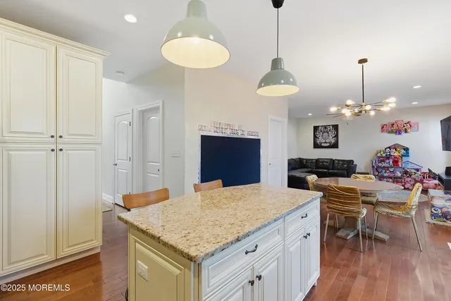 a bathroom with a granite countertop sink and a toilet