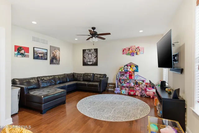a bedroom with furniture and a wooden floor