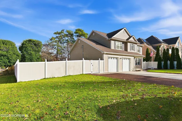 a view of a house with a yard and plants