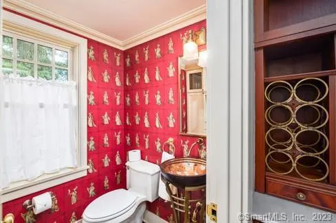 a bathroom with a sink a toilet and shower curtain