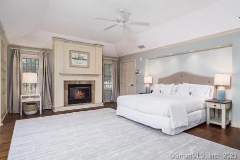 a bedroom with a large bed and a fireplace