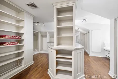 a kitchen with white cabinets and counter space