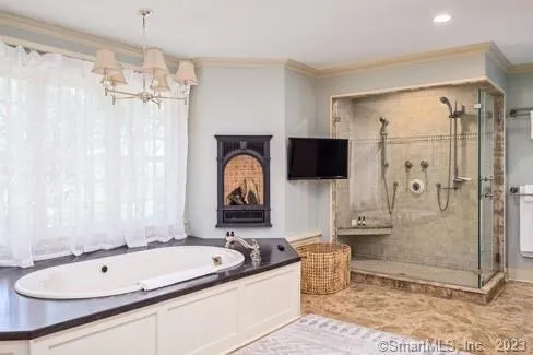 a bathroom with a tub a sink and mirror