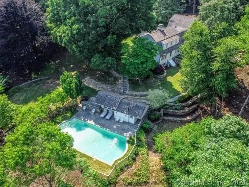 an aerial view of a house with a yard