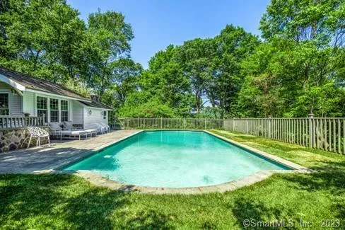 a view of a house with swimming pool and sitting area