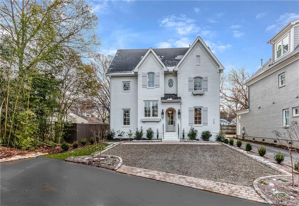 748 Ellsworth Road, Unit 47 Charlotte, NC 28211 - Photo 1 of 34 a view of a white house with a street and large trees