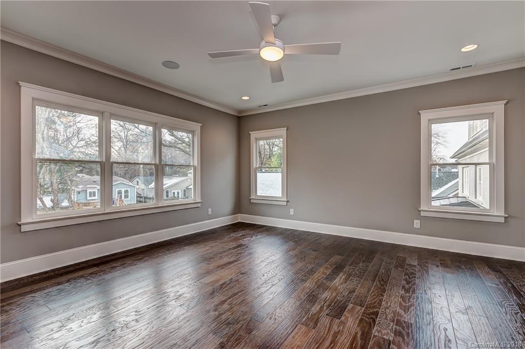748 Ellsworth Road, Unit 47 Charlotte, NC 28211 - Photo 19 of 34 a view of an empty room with wooden floor and a window
