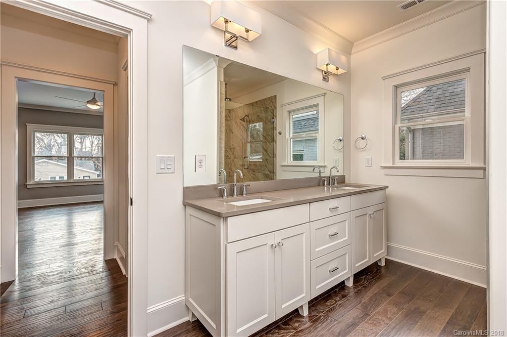 748 Ellsworth Road, Unit 47 Charlotte, NC 28211 - Photo 20 of 34 a bathroom with a granite countertop sink mirror and next to a window