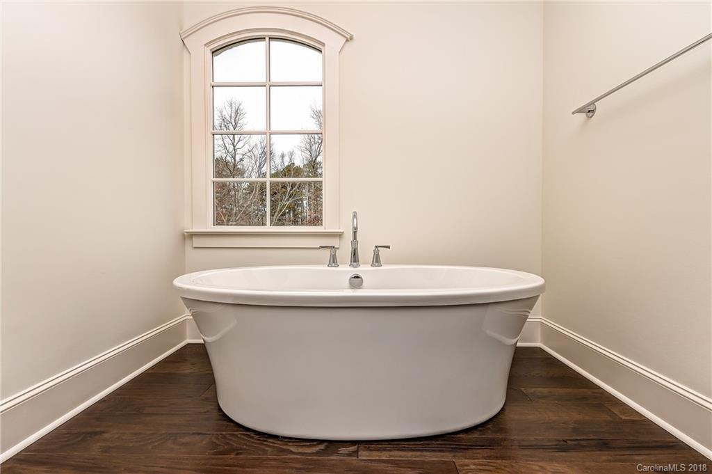 748 Ellsworth Road, Unit 47 Charlotte, NC 28211 - Photo 21 of 34 a white bath tub sitting next to a window