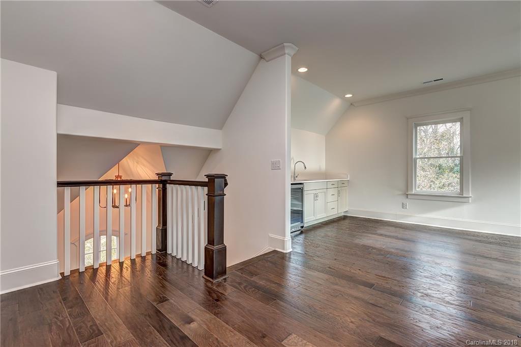 748 Ellsworth Road, Unit 47 Charlotte, NC 28211 - Photo 25 of 34 an empty room with wooden floor and windows