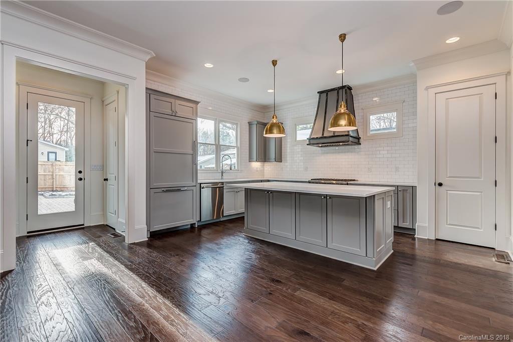 748 Ellsworth Road, Unit 47 Charlotte, NC 28211 - Photo 6 of 34 a kitchen with stainless steel appliances granite countertop a stove a refrigerator and a microwave