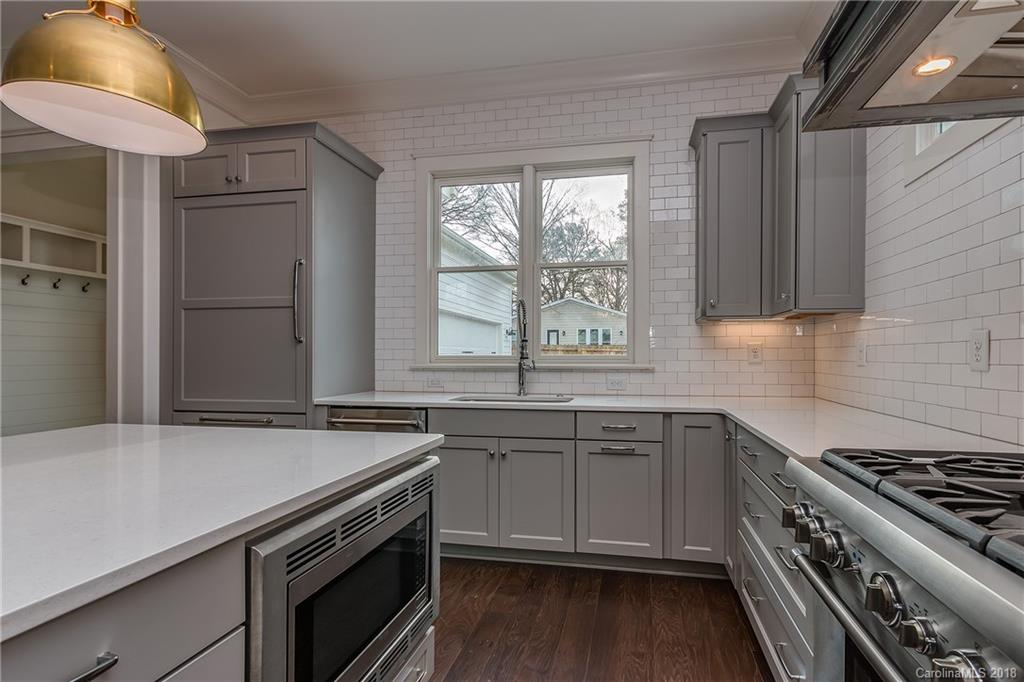 748 Ellsworth Road, Unit 47 Charlotte, NC 28211 - Photo 7 of 34 a kitchen with a sink stove and cabinets