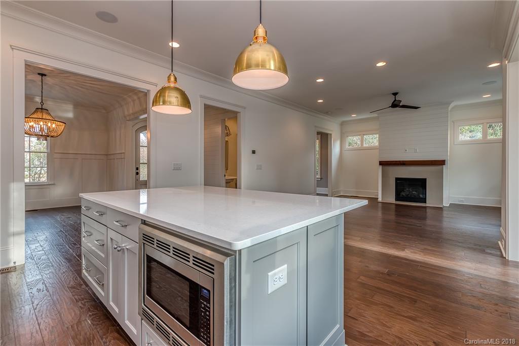 748 Ellsworth Road, Unit 47 Charlotte, NC 28211 - Photo 8 of 34 a kitchen with a stove and a wooden floor