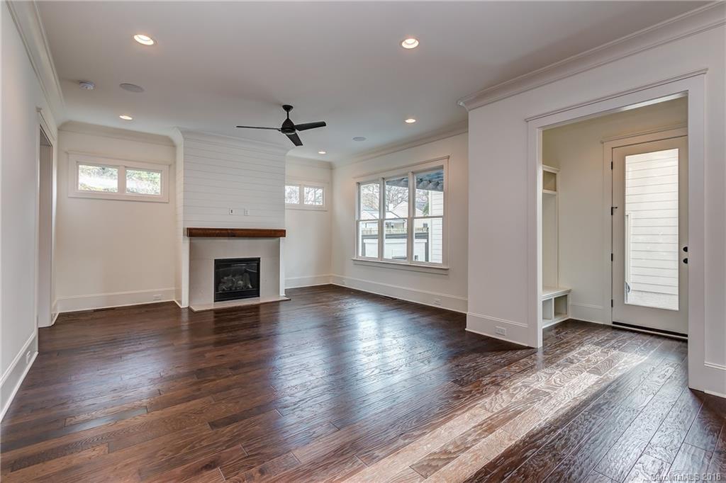 748 Ellsworth Road, Unit 47 Charlotte, NC 28211 - Photo 10 of 34 an empty room with wooden floor fireplace and windows