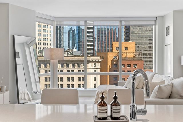 a living room with furniture and floor to ceiling windows
