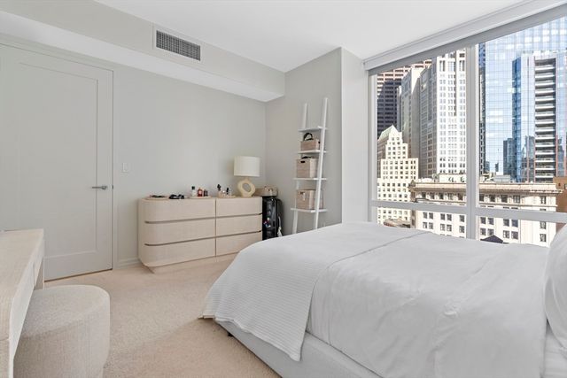 a bedroom with a bed and a large window