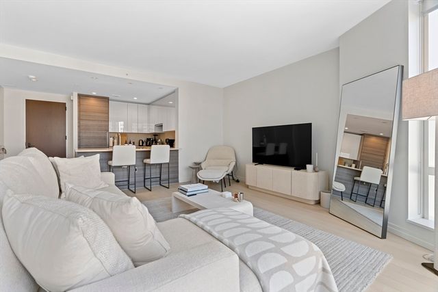 a hotel room with a bed a flat screen tv and a couch