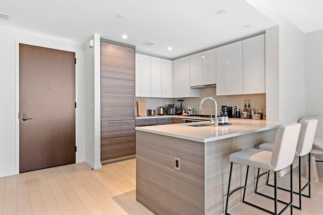 a kitchen with kitchen island cabinets and white appliances
