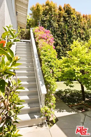 a living room with furniture fireplace and a large window