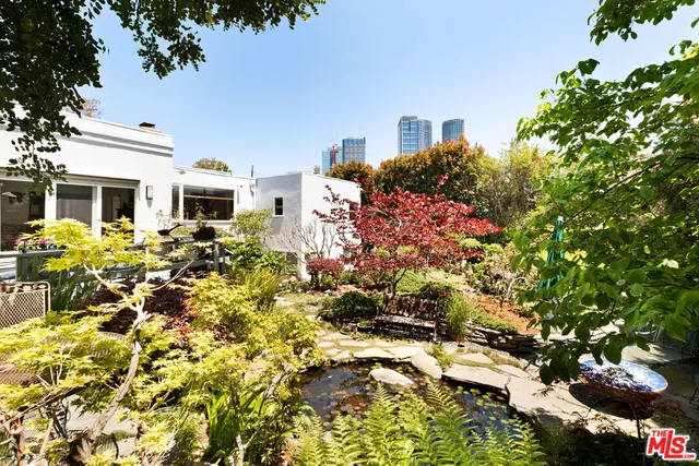a view of a house with a yard and garden
