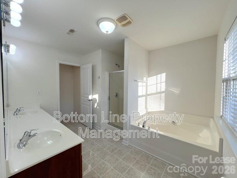 9737 Tidal Court Huntersville, NC 28078 - Photo 11 of 21 a spacious bathroom with a tub sink and mirror