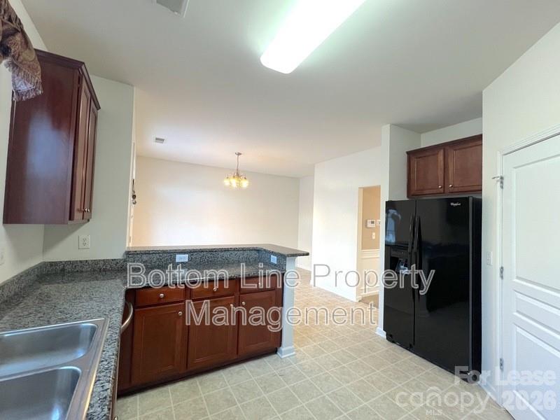 9737 Tidal Court Huntersville, NC 28078 - Photo 8 of 21 a kitchen with a refrigerator and a sink