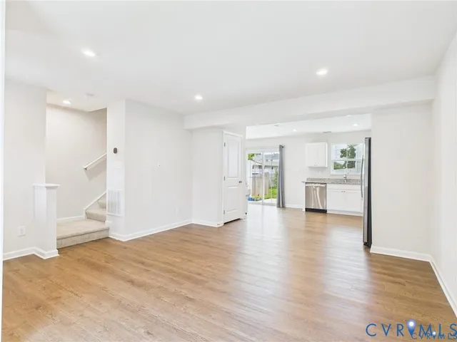 a front view of a house with a yard and chairs