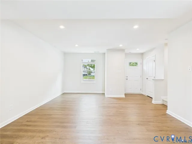 a view of kitchen with refrigerator sink and cabinets